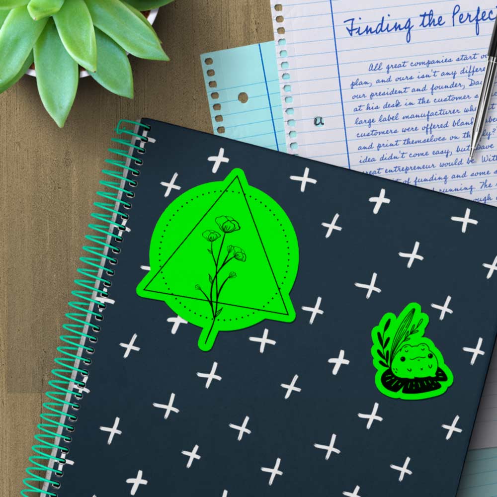 Fluorescent green stickers on a notebook.