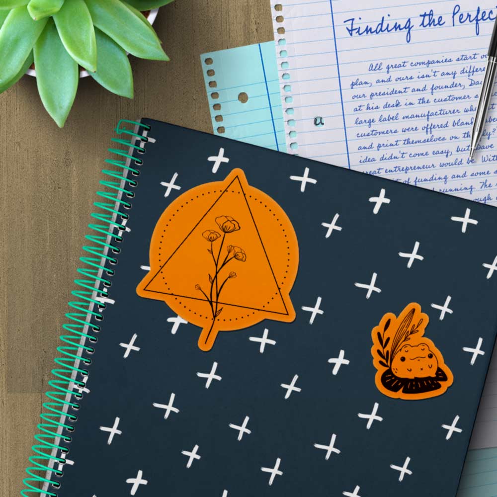 Fluorescent orange stickers on a notebook.