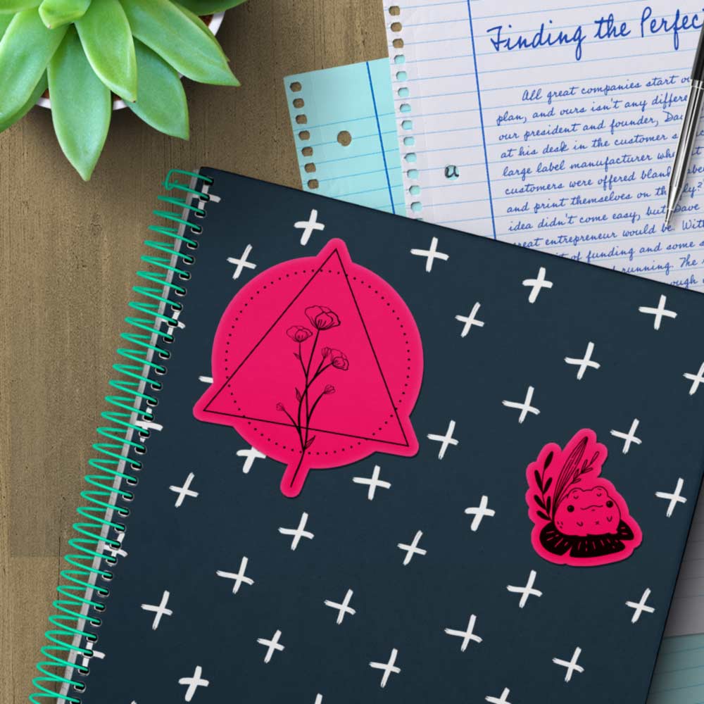 Fluorescent pink stickers on a notebook.