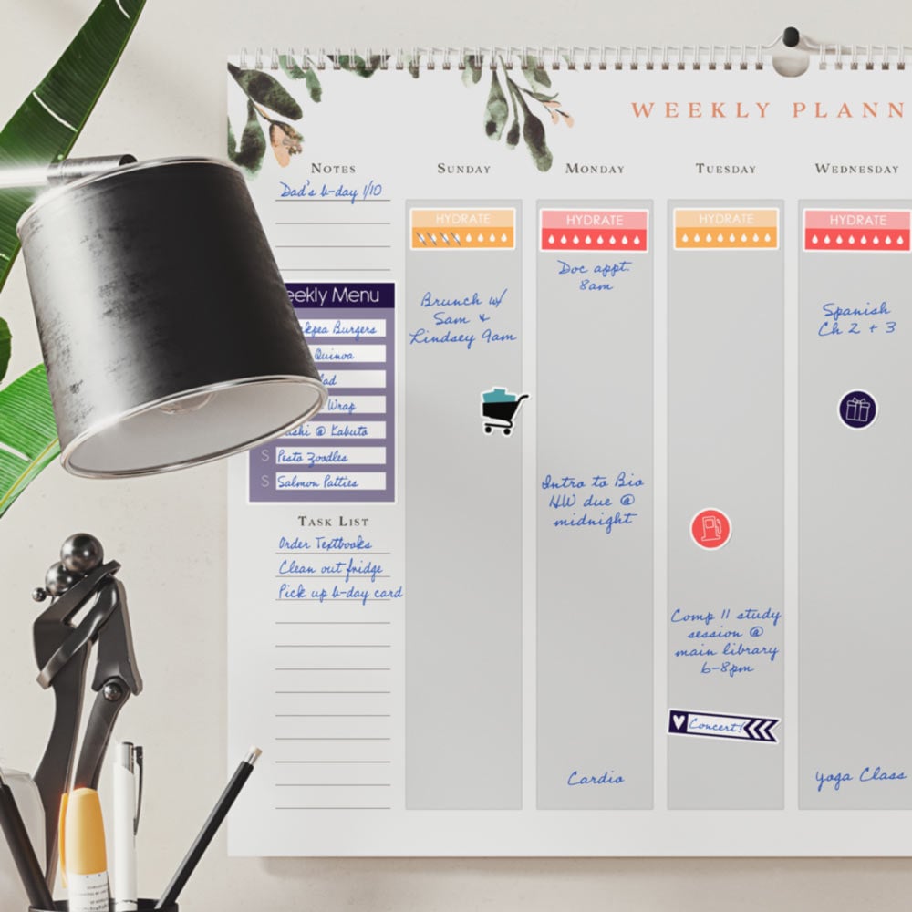 Removable white matte planner stickers on a calendar.