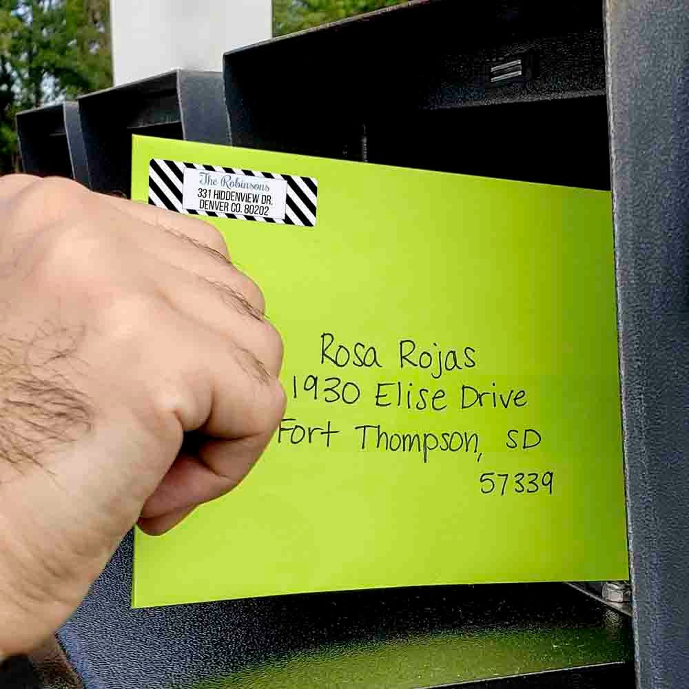 1.75" x 0.5" aggressive white matte return address label on neon envelope