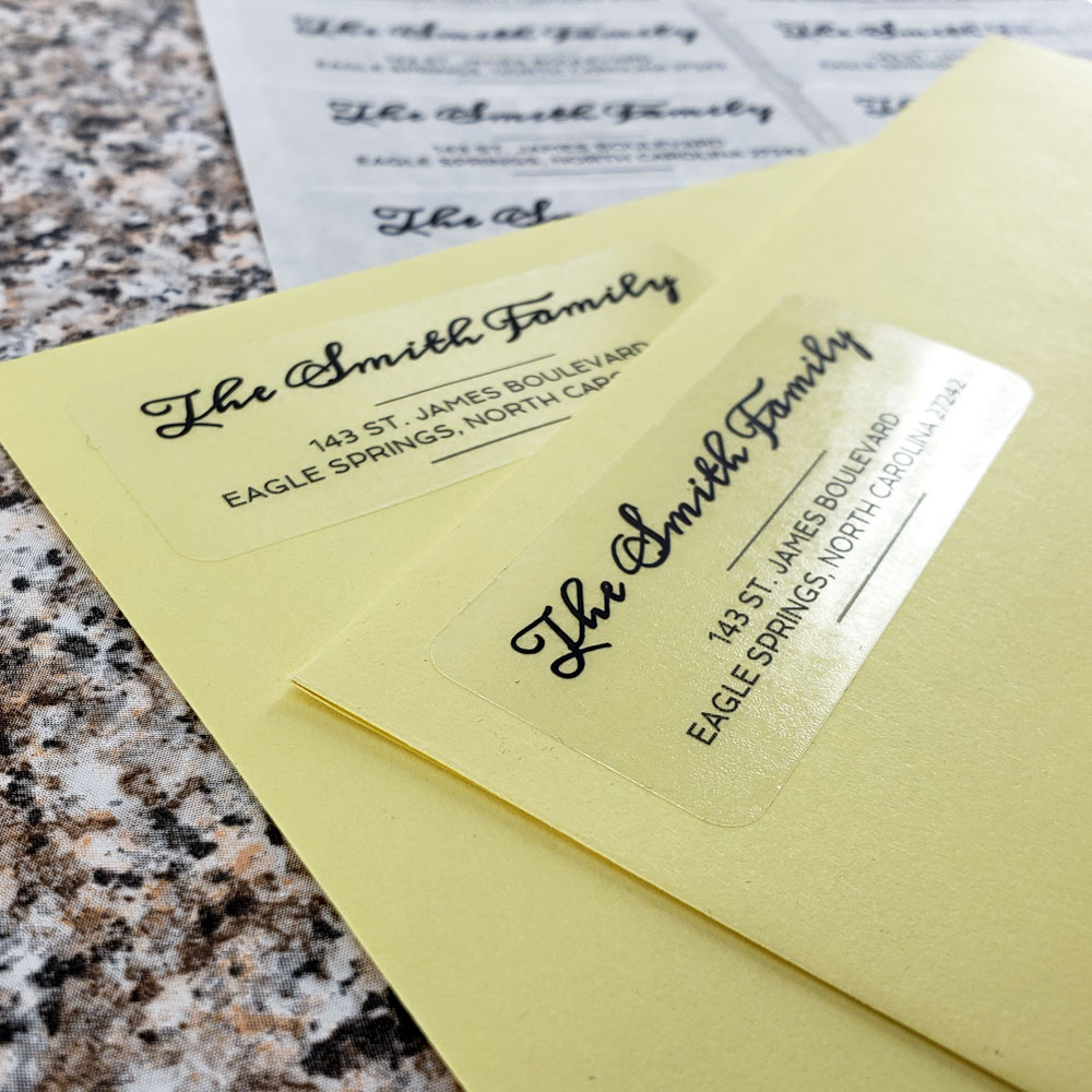 Personalized 2.62" x 1" standard size address label in our clear gloss material, placed on a pastel yellow envelope