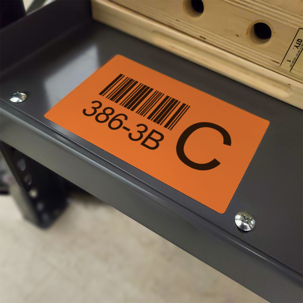 Orange direct thermal label on a shelf.