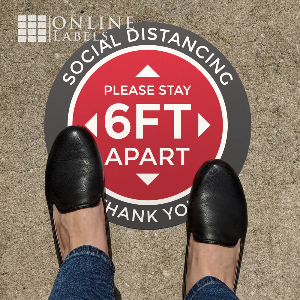 Feet on social distancing floor sign (please stay 6 ft apart, thank you)