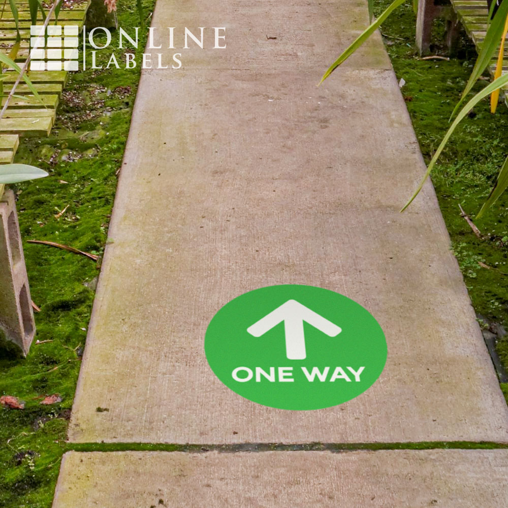One way floor sticker (green) used on sidewalks outside to direct crowds during covid