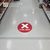 Red "one way" floor sticker on aisle to prevent customers from getting too close indoors during coronavirus
