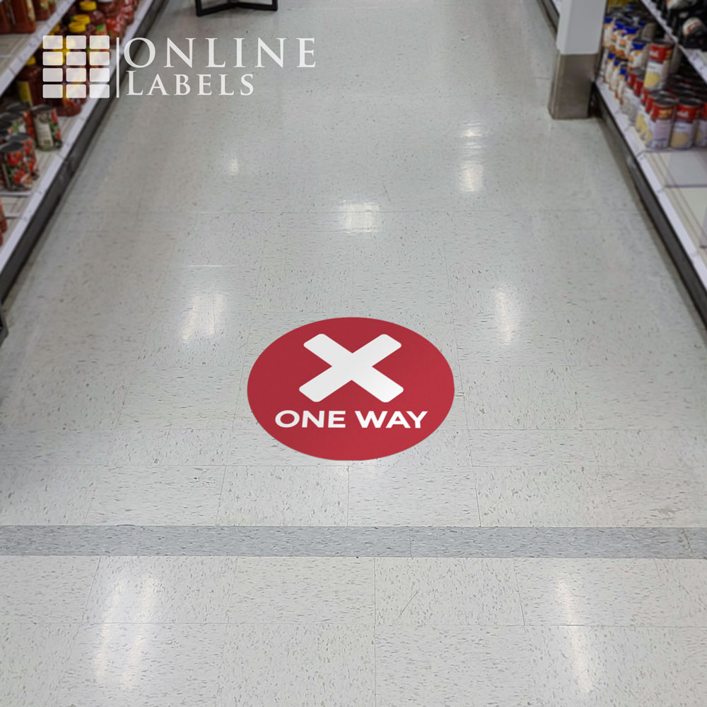 Red "one way" floor sticker on aisle to prevent customers from getting too close indoors during coronavirus