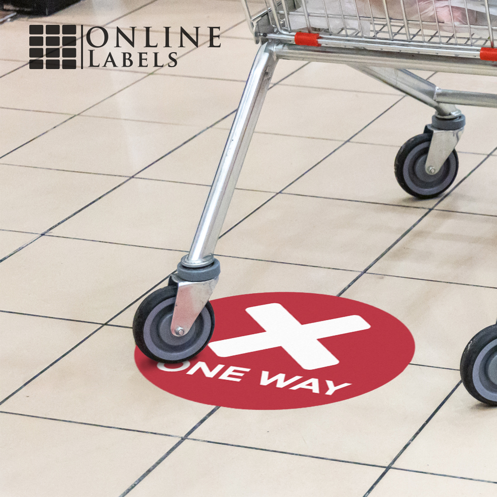 Grocery cart rolling over red "one way" aisle sticker
