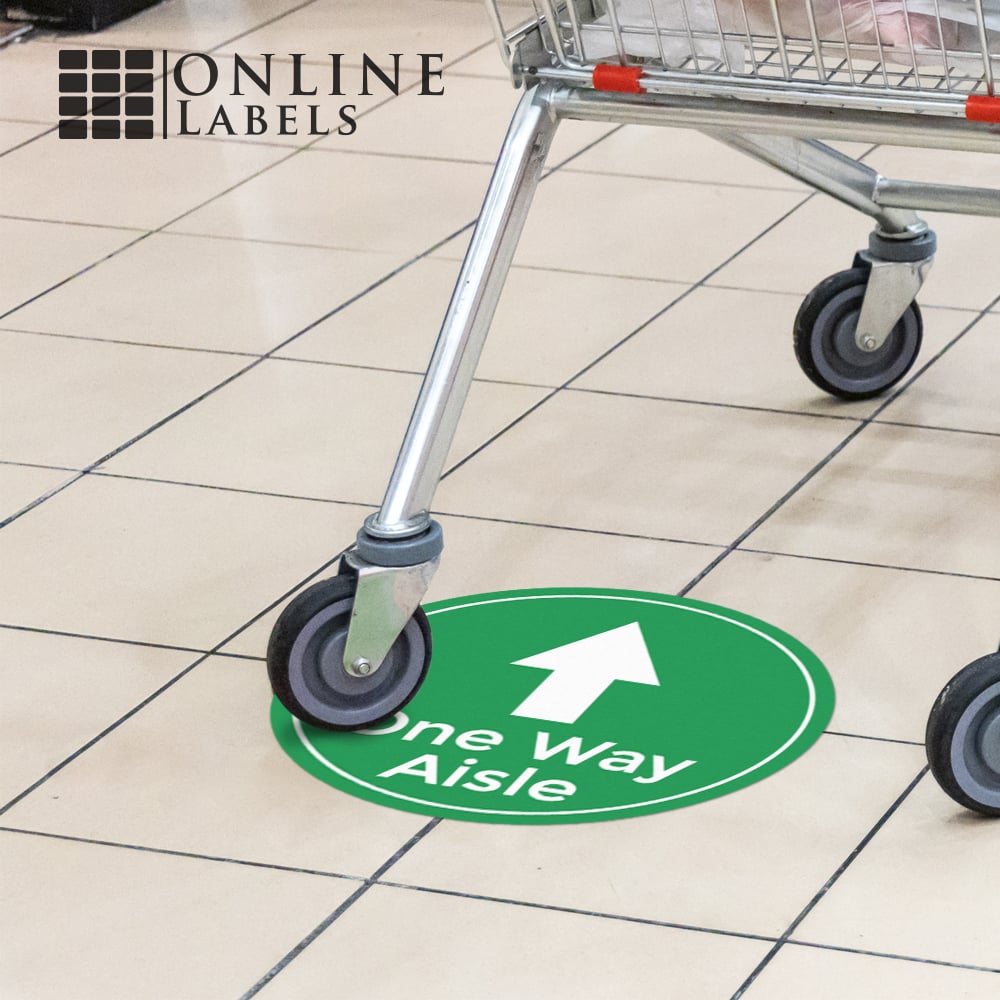 Social distancing floor sign in grocery store (covid precaution "one way aisle" sign, green with white arrow))