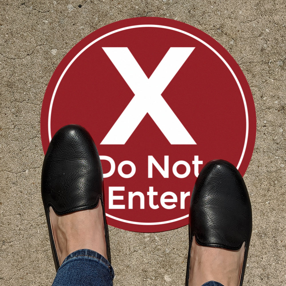 Feet on red "do not enter" aisle directional warning sticker for covid social distancing safety