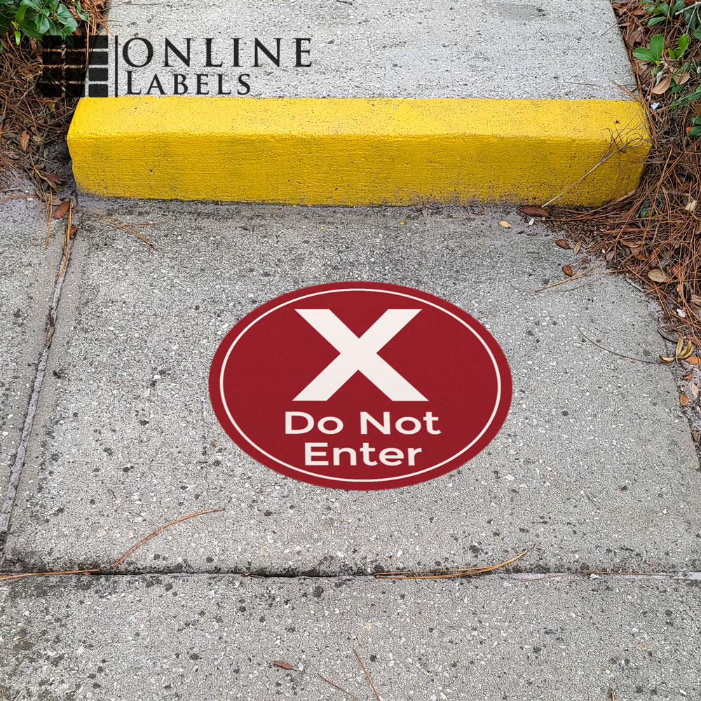 Red "do not enter" floor sticker for coronavirus safety and social distancing; used on cement outdoors