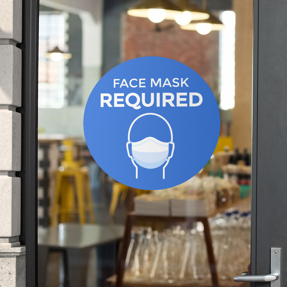 Blue "face mask required" window/wall sticker on glass door pane of restaurant