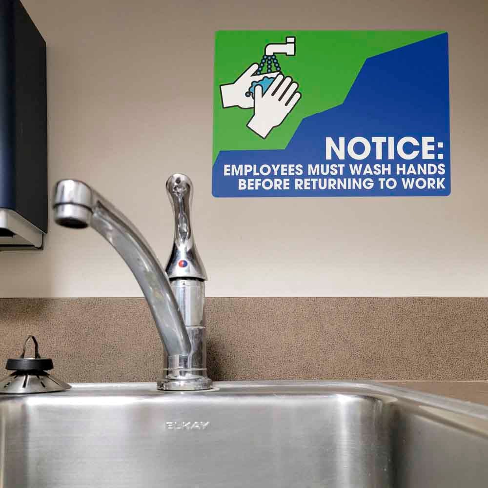 Employees Must Wash Hands safety sticker by a sink.