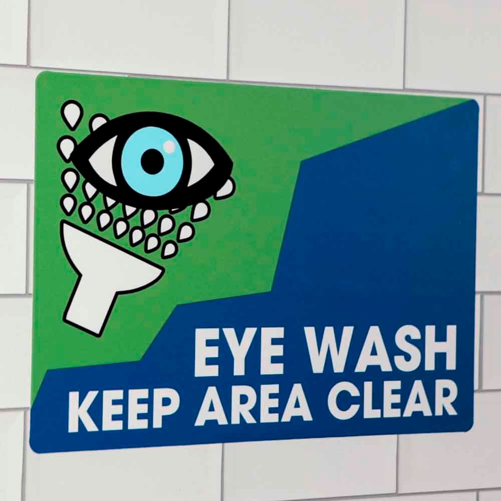 Eye wash safety sticker on a wall.